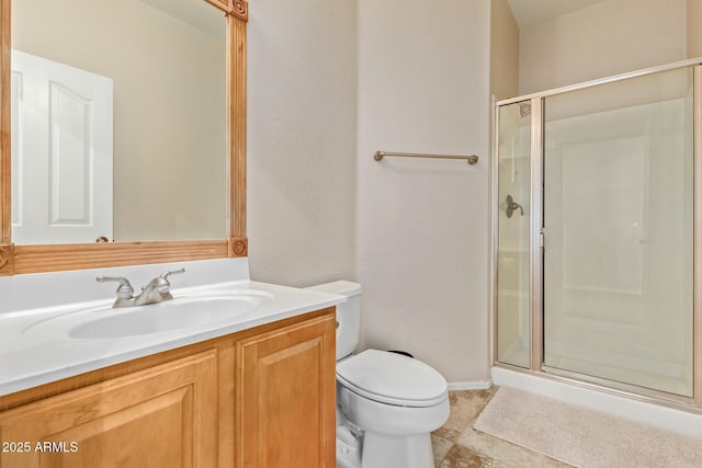 bathroom with walk in shower, vanity, and toilet