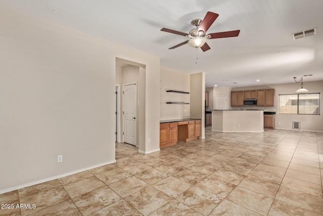 unfurnished living room with ceiling fan