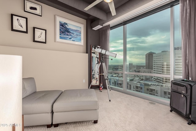 living area featuring light carpet and ceiling fan