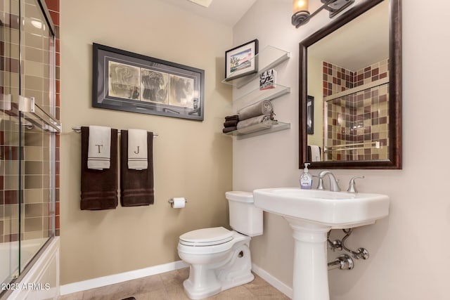 bathroom with tile patterned flooring, combined bath / shower with glass door, and toilet