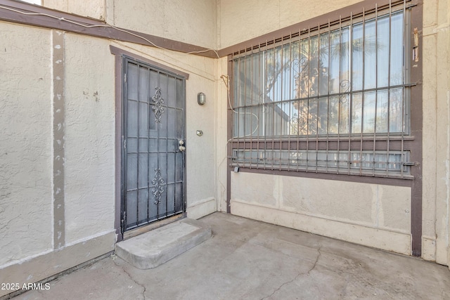 entrance to property featuring stucco siding