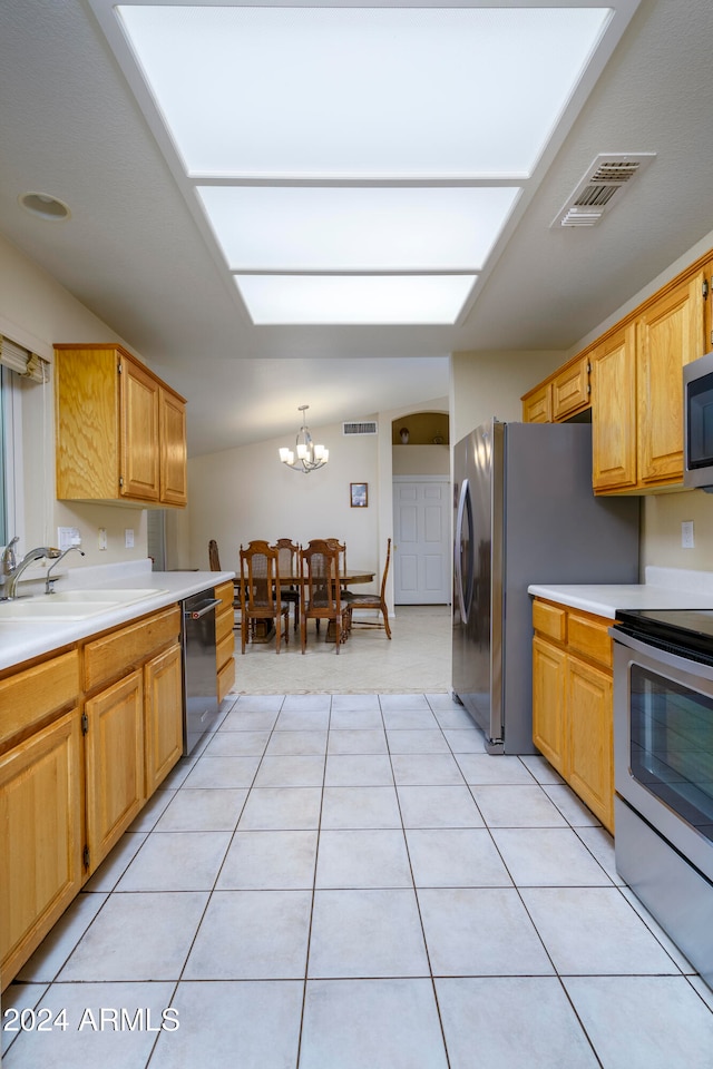 kitchen with stainless steel appliances, a notable chandelier, sink, light tile patterned floors, and pendant lighting