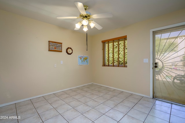 empty room featuring ceiling fan and light tile patterned floors