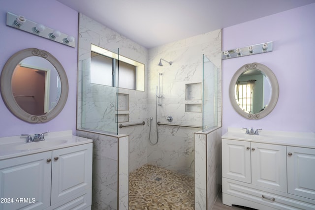 bathroom with vanity, a tile shower, and plenty of natural light