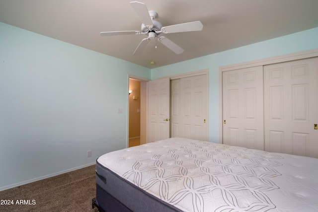 carpeted bedroom with multiple closets and ceiling fan