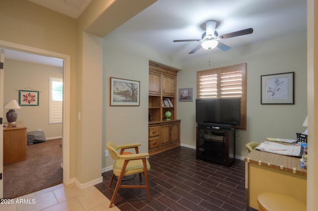 office with ceiling fan and baseboards