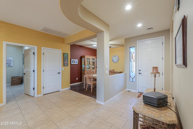 foyer entrance with recessed lighting, visible vents, baseboards, and light tile patterned flooring