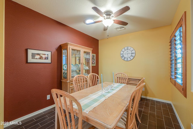 dining area featuring ceiling fan, baseboards, and visible vents