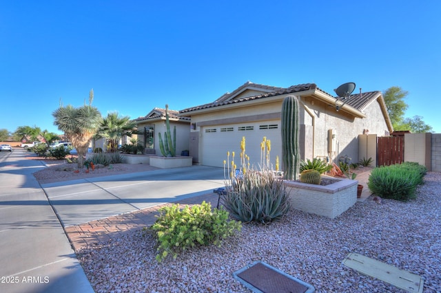 single story home with an attached garage, a tiled roof, stucco siding, and concrete driveway