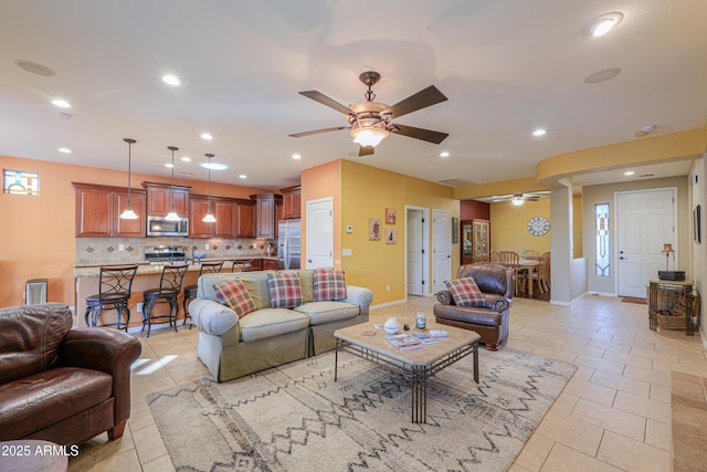 living area featuring ceiling fan, recessed lighting, baseboards, and light tile patterned floors