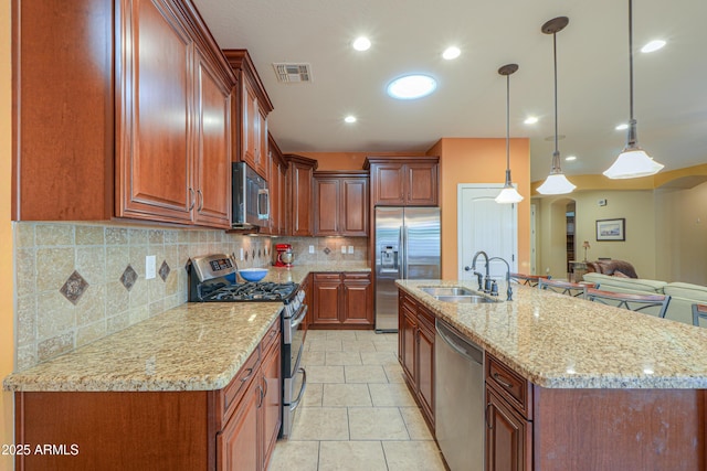 kitchen featuring a sink, decorative backsplash, arched walkways, appliances with stainless steel finishes, and visible vents
