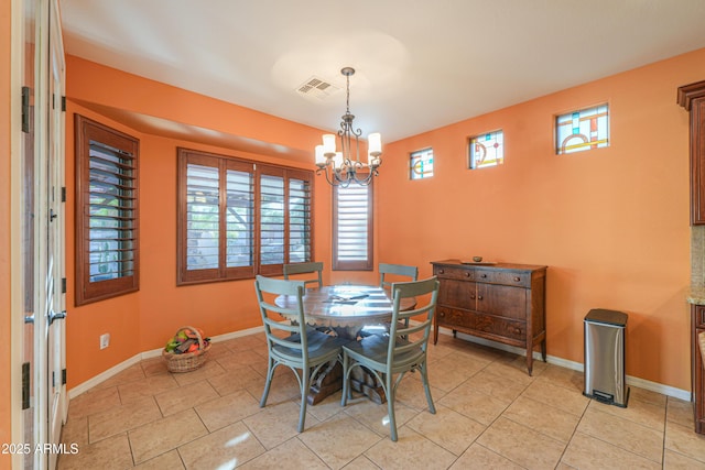 dining area featuring baseboards, visible vents, an inviting chandelier, and light tile patterned flooring