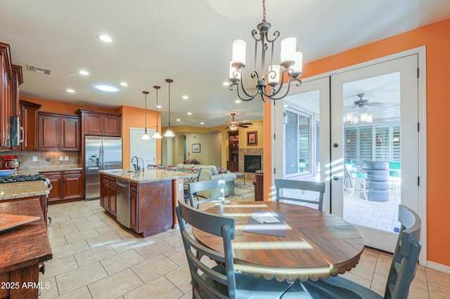 dining area featuring ceiling fan with notable chandelier, visible vents, recessed lighting, and light tile patterned floors