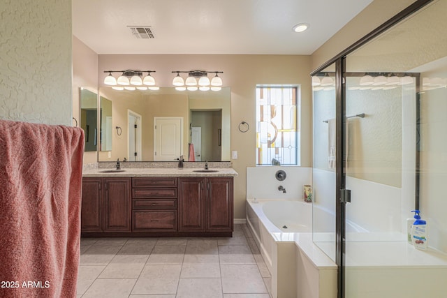 full bathroom with a garden tub, tile patterned floors, a sink, and a stall shower