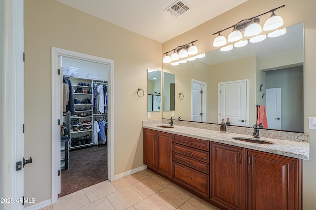 full bath with double vanity, visible vents, tile patterned flooring, and a sink