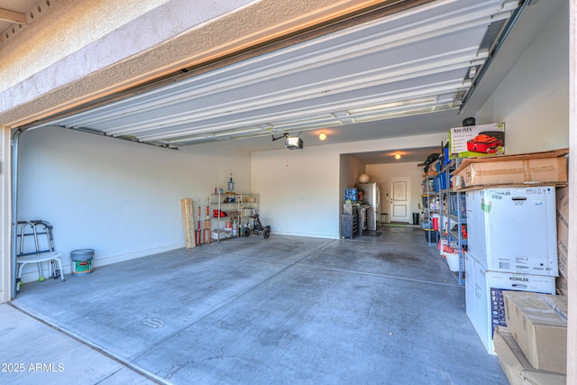 garage with freestanding refrigerator and a garage door opener