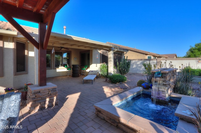 view of patio / terrace featuring a ceiling fan and fence