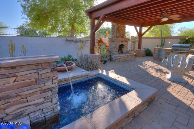 view of patio / terrace with a fenced backyard, a grill, an outdoor stone fireplace, an outdoor kitchen, and ceiling fan