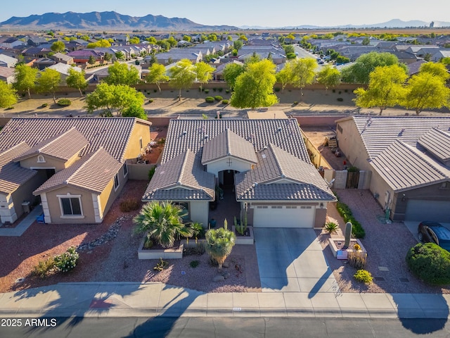 birds eye view of property with a mountain view and a residential view