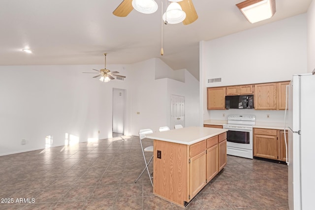 kitchen with white appliances, a breakfast bar area, ceiling fan, high vaulted ceiling, and a kitchen island