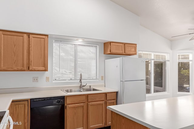 kitchen with sink, range, vaulted ceiling, black dishwasher, and white fridge