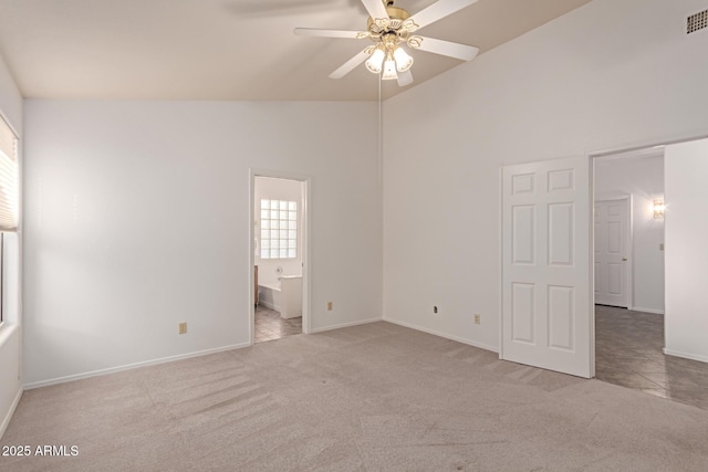 carpeted empty room with lofted ceiling and ceiling fan