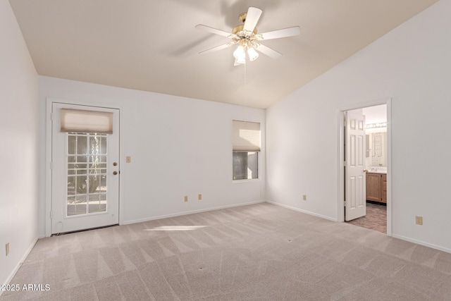 unfurnished bedroom with ceiling fan, ensuite bath, lofted ceiling, and light carpet