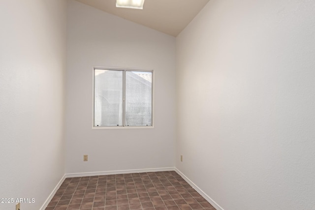 spare room featuring vaulted ceiling