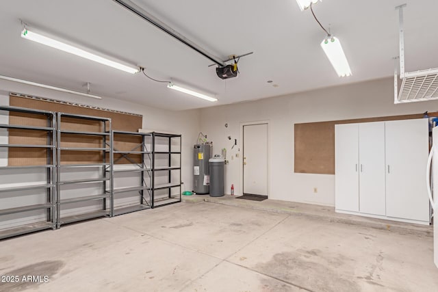 garage featuring a garage door opener and water heater