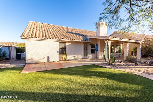 back of property featuring a yard, a patio, and central air condition unit