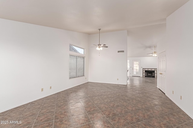 unfurnished living room featuring ceiling fan, a fireplace, and high vaulted ceiling