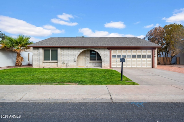 ranch-style house featuring a garage and a front lawn