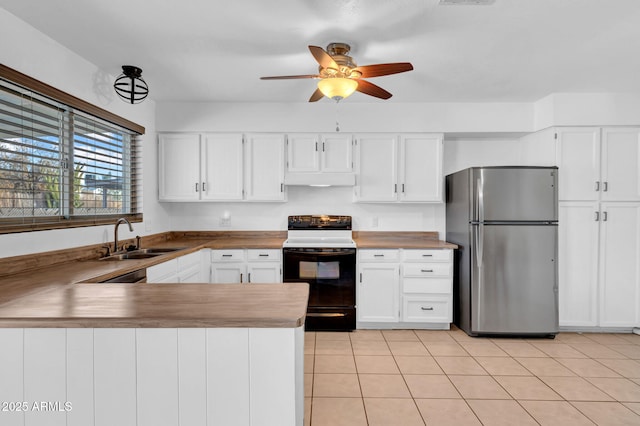 kitchen featuring white range with electric stovetop, white cabinetry, stainless steel refrigerator, and sink