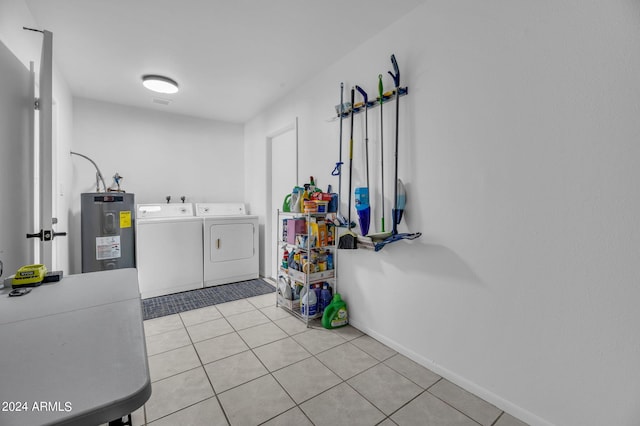 laundry area with light tile patterned flooring, independent washer and dryer, and water heater