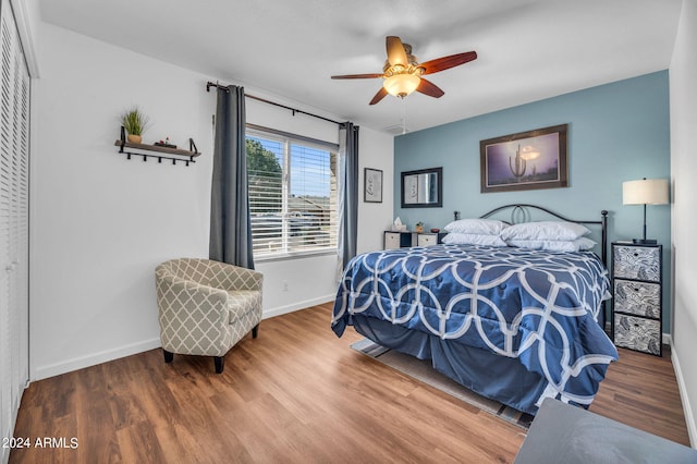 bedroom with hardwood / wood-style floors and ceiling fan