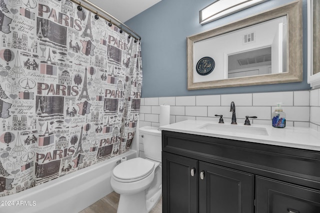 full bathroom featuring vanity, hardwood / wood-style flooring, toilet, tile walls, and shower / tub combo with curtain