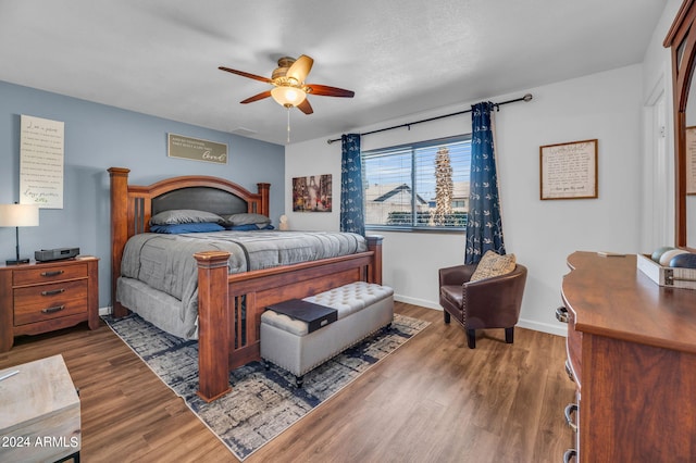 bedroom featuring wood-type flooring, a textured ceiling, and ceiling fan