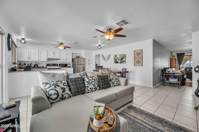 living room featuring ceiling fan and light tile patterned floors