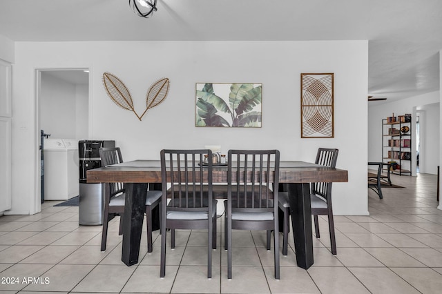 dining area featuring ceiling fan, light tile patterned floors, and washer / clothes dryer