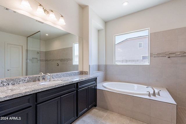 bathroom featuring tile patterned flooring, vanity, and separate shower and tub