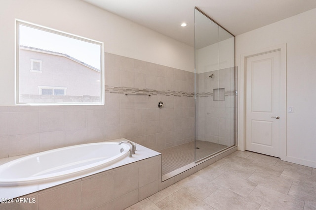 bathroom featuring separate shower and tub