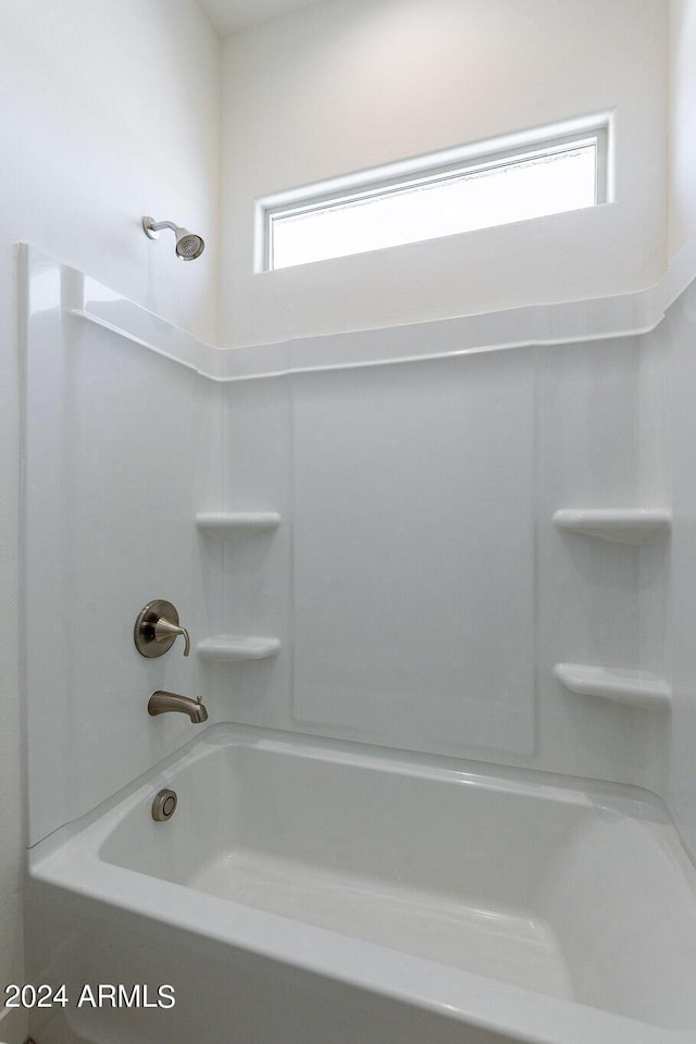 bathroom with bathing tub / shower combination