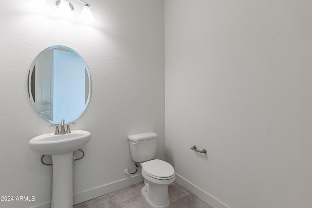 bathroom featuring tile patterned flooring and toilet