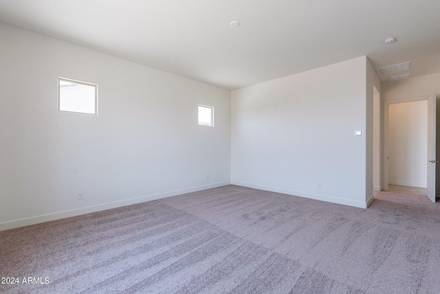 unfurnished room with light colored carpet