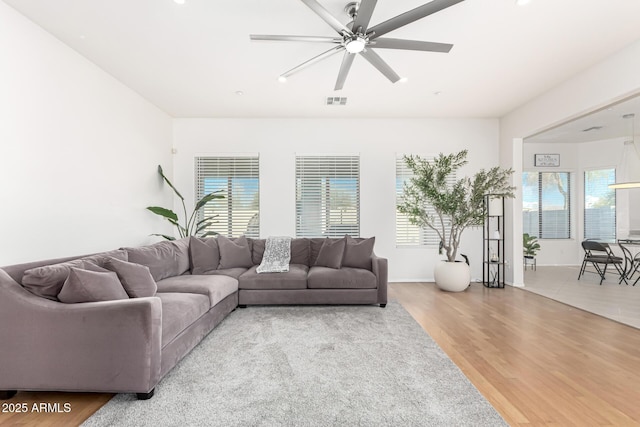 living room featuring hardwood / wood-style floors and ceiling fan