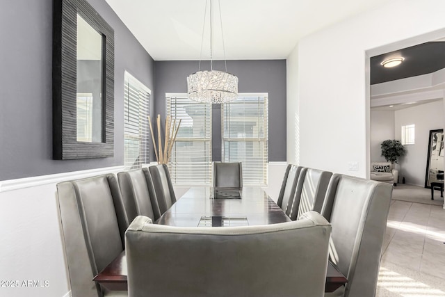 dining area with a chandelier and light tile patterned floors