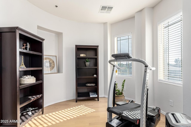 workout room featuring light hardwood / wood-style flooring