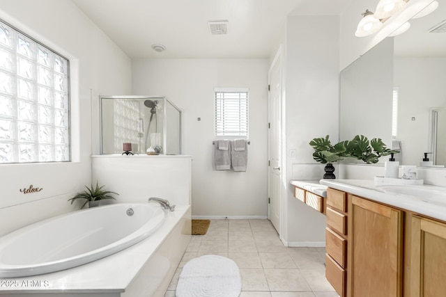 bathroom featuring tile patterned floors, separate shower and tub, and vanity