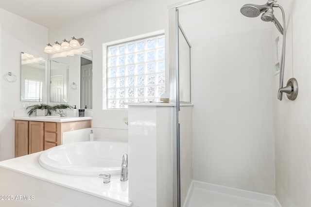 bathroom featuring shower with separate bathtub, a wealth of natural light, and vanity