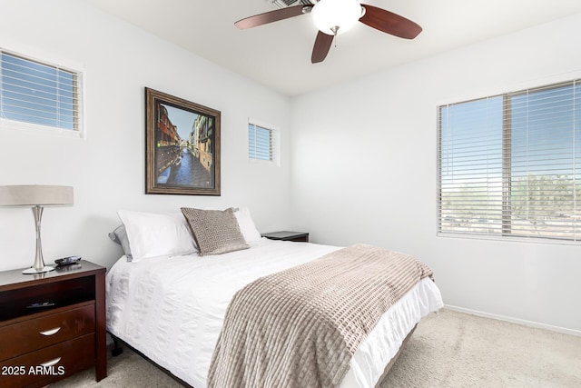 bedroom featuring ceiling fan and light carpet